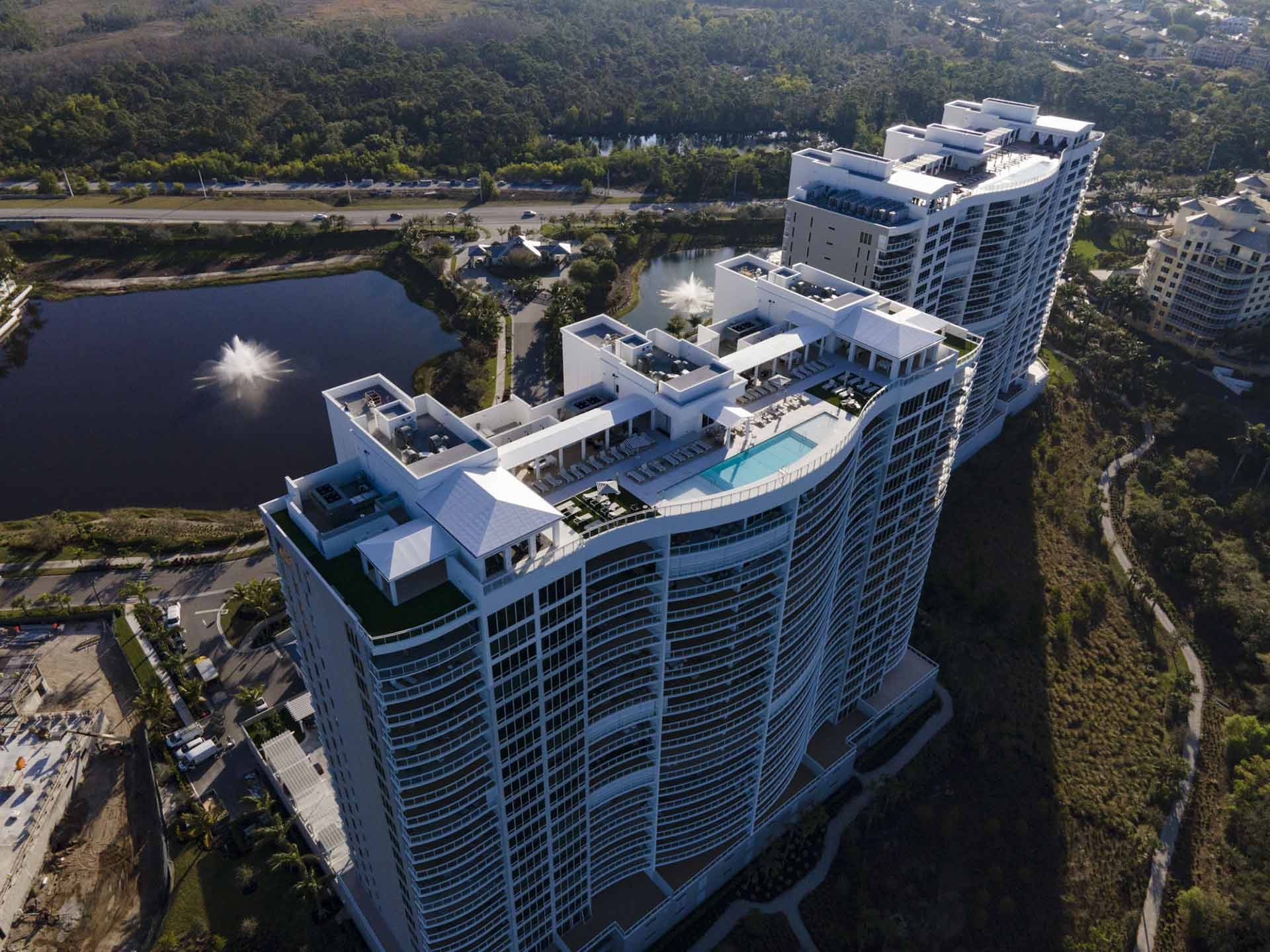 Aerial view of the Kalea Bay tower rooftop pool and amenity deck in Naples